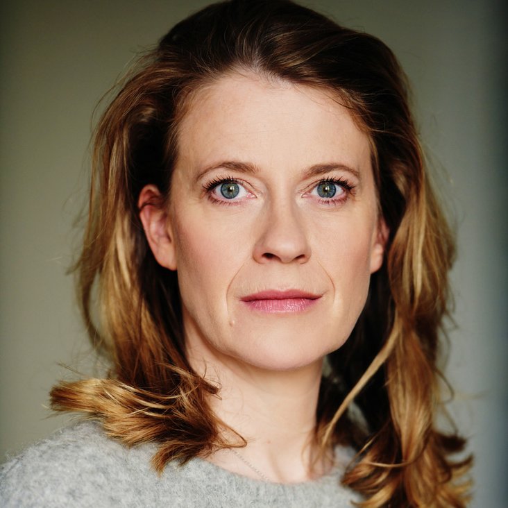 Portraitfoto von Caroline Peters, sie trägt einen grauen Pullover