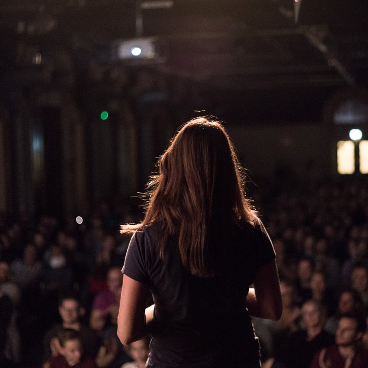 Teilnehmende des Science Slam auf der Bühne vor Publikum