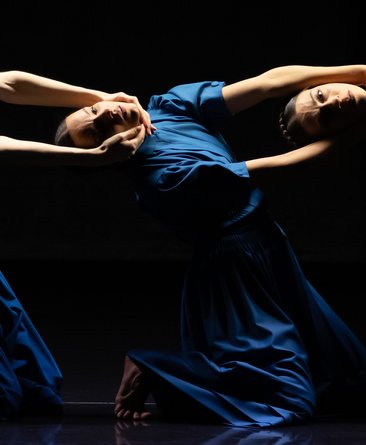Stage photo from "The Seven Sins", three dancers pose in blue dresses