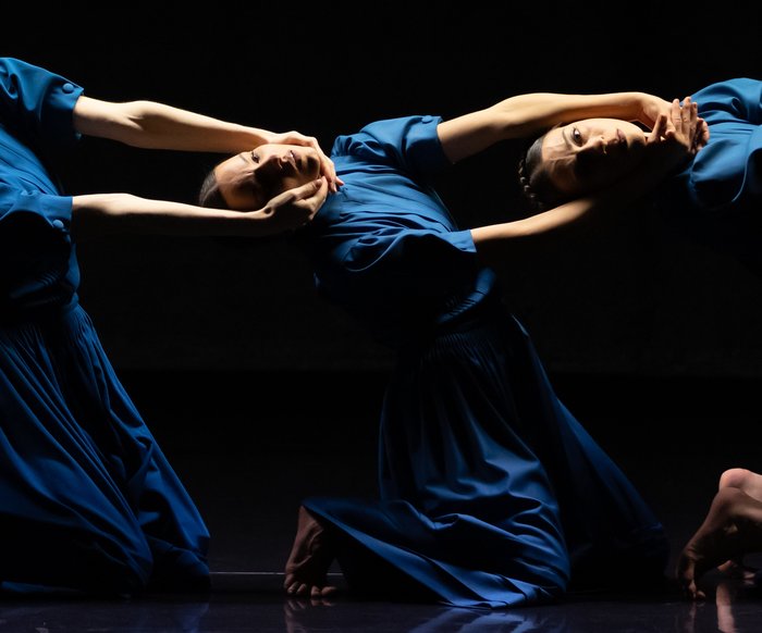 Stage photo from "The Seven Sins", three dancers pose in blue dresses