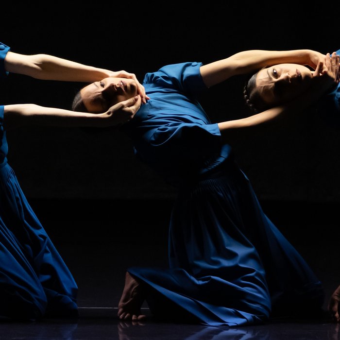 Stage photo from "The Seven Sins", three dancers pose in blue dresses